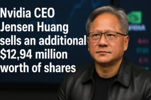 Jensen Huang, CEO of Nvidia, in a leather jacket with a serious expression, positioned beside a headline that reads “Nvidia CEO Jensen Huang sells an additional $12.94 million worth of shares,” with a blurred stock market chart in the background.