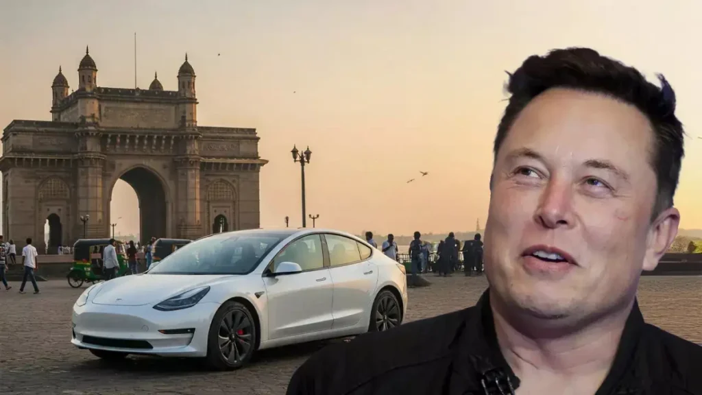 Elon Musk smiling next to a white Tesla parked in front of Mumbai’s Gateway of India at sunset, highlighting Tesla’s entry into the Indian market.